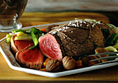 Roast beef with vegetables on dish, close-up
