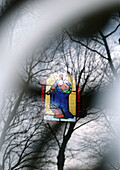 Stained-glass window and trees, superimposition of images