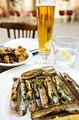 Steamed razor clams, glass of beer
