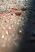 Water droplets on rocky surface, close-up