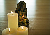 Candles and buddha statuette