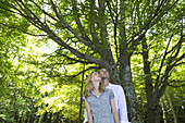 Couple in woods, looking up