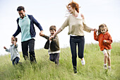 Family running together in field