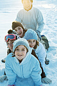 Group having fun in snow, portrait