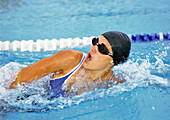 Female swimmer taking breath, close-up
