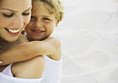 Boy and mother on beach, portrait