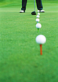Golfer on driving range, low section