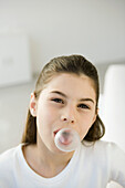 Girl blowing bubble with chewing gum, portrait
