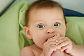 Baby with foot in mouth, close-up