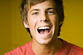 Young man laughing, portrait