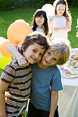 Young friends together at outdoor party, portrait