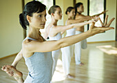 Yoga class standing in shiva posture