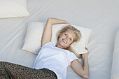 Young woman relaxing on bed