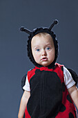 A baby boy in a ladybug costume