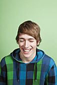 A laughing teenage boy, portrait, studio shot