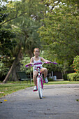 Girl riding bike through park