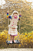 Girl on swing in park