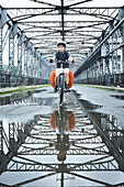 Boy riding across bicycle bridge in Czech Republic