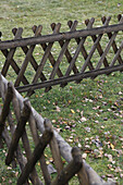 Crisscross wooden fence on grass