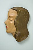A retro wall hanging, female mannequin profile