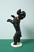 A retro dog figurine begging on its hind legs