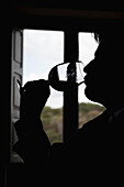 A man taking a sip of wine