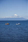 View of boats on Lake Llanquihue and Osorno Volcano, Puerto Varas, Chile