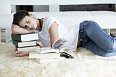 Woman sleeping on her books