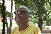 A senior man looking up, outdoors