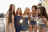 Five young women standing on a jetty next to the Spree River, Berlin, Germany