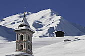 Church tower and snowy mountain in background