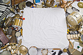 Heaps of various percussion instruments surrounding a white cloth