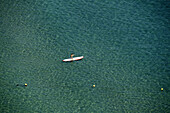 Person rowing on paddleboard on the sea