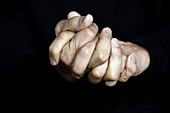 Close-up of clasped hands