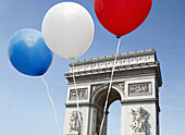 Balloons in the colors of the French flag in front of the Arc De Triomphe