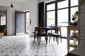 A hip tidy dining room with flooring that has a star shaped pattern
