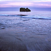 Seascape and island under a dusk sky