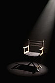 A spot lit directors chair