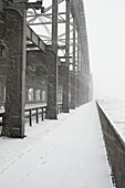 The metal structure of a bridge in a snowstorm