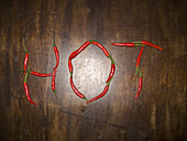 Red chili peppers spelling the word HOT