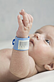 A baby with a hospital ID bracelet her wrist, focus on wrist