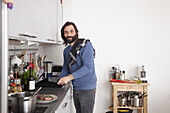 Portrait of man preparing food in domestic kitchen