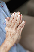 Detail of a senior woman praying
