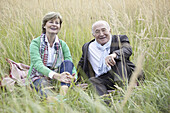 Couple sitting in field