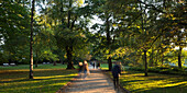 People walking through Schrevenpark, Kiel, Schleswig-Holstein, Germany