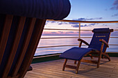 Deck chairs aboard cruise ship MS Deutschland (Reederei Peter Deilmann) at dusk, Mediterranean Sea, near Italy