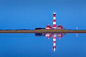 Lighthouse reflecting in the flats, Westerhever lighthouse, Eiderstedt peninsula, Schleswig-Holstein, Germany