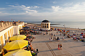 People sitting in a cafe on the beach promenade, Pavilion in the background, Borkum, Ostfriesland, Lower Saxony, Germany