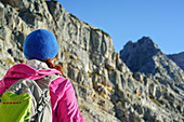 Woman hiking towards Rothorn, Nurracher Hoehenweg, Ulrichshorn, Loferer Steinberge range, Tyrol, Austria