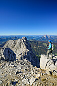 Woman standing on summit of Rothorn with view to Rothoernl and Kaiser range, Nurracher Hoehenweg, Rothorn, Loferer Steinberge range, Tyrol, Austria
